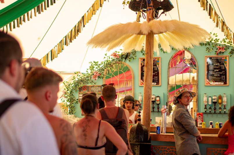 Guests beneath colourful bunting inside an event bar