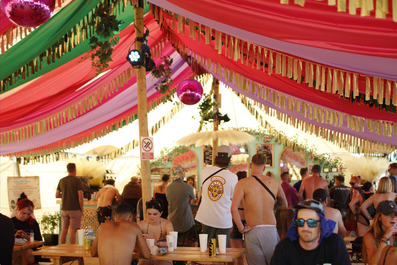 Guests inside a colourful bar at Boomtown