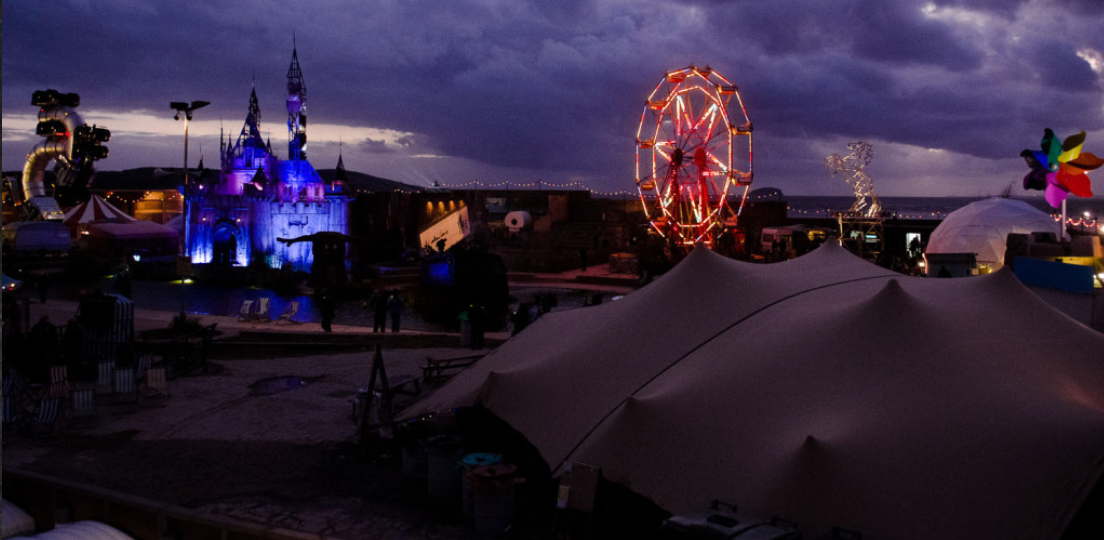 Banksy’s Dismaland illuminated at night