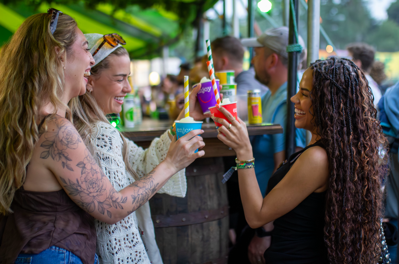 Guests raising colourful drinks together
