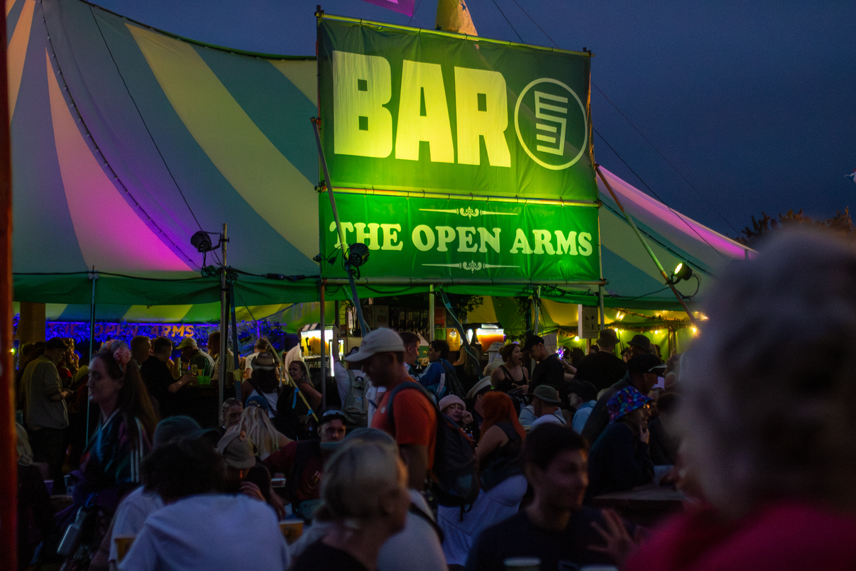 The Open Arms bar at Glastonbury at dusk